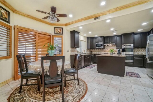 18429 Germain St, Porter Ranch, CA 91326 - dining area with ceiling fan, crown molding, and baseboards