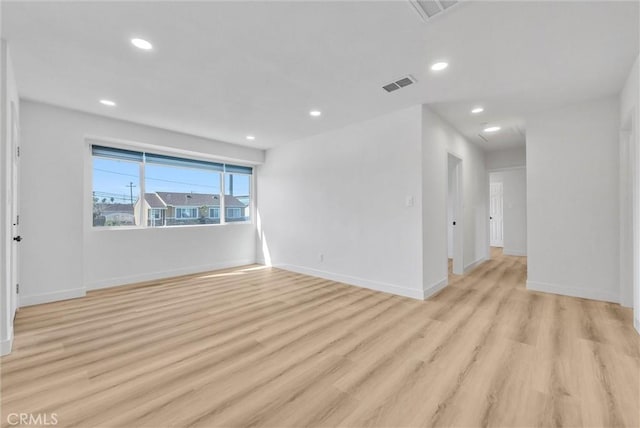 empty room featuring recessed lighting, visible vents, light wood finished floors, and baseboards