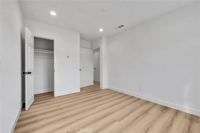 unfurnished bedroom featuring light wood-type flooring, visible vents, baseboards, and recessed lighting