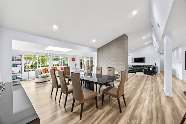 dining room featuring recessed lighting, visible vents, vaulted ceiling, and light wood finished floors