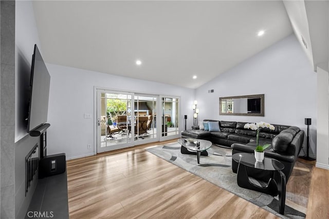 living room with recessed lighting, visible vents, high vaulted ceiling, and wood finished floors