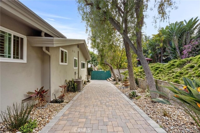 exterior space featuring central AC unit and fence