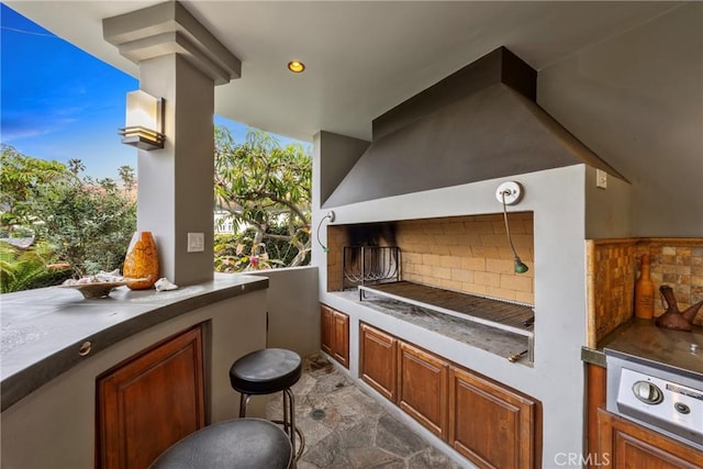 view of patio / terrace with exterior kitchen and a balcony