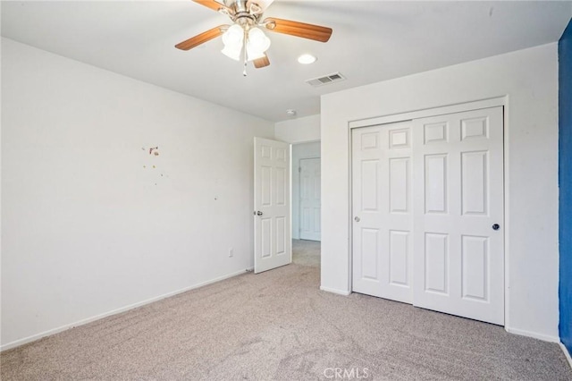 unfurnished bedroom featuring a closet, visible vents, baseboards, and carpet