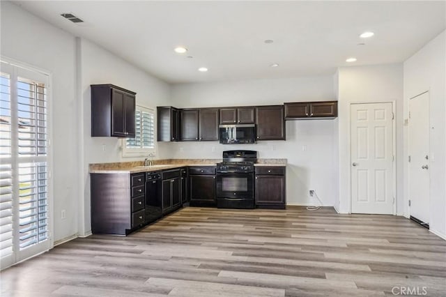 kitchen featuring visible vents, light countertops, recessed lighting, light wood-style floors, and black appliances