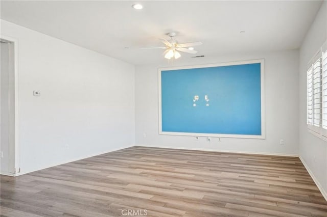 unfurnished room featuring recessed lighting, baseboards, a ceiling fan, and wood finished floors