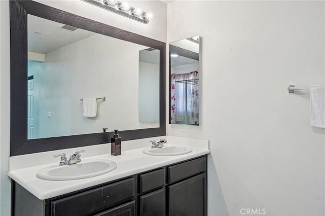 bathroom featuring double vanity and a sink