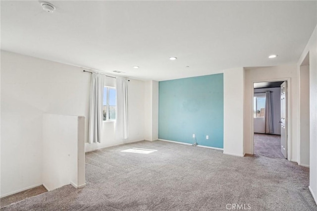 carpeted empty room with visible vents, recessed lighting, and baseboards