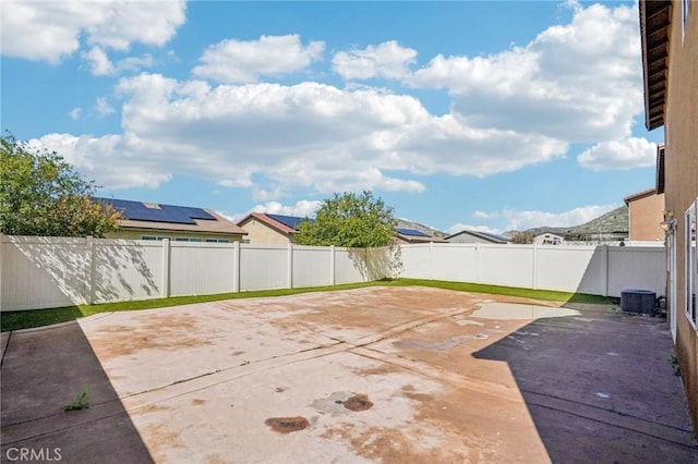 view of patio / terrace with central air condition unit and a fenced backyard