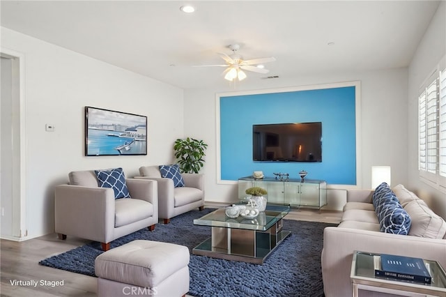 living area featuring ceiling fan and wood finished floors