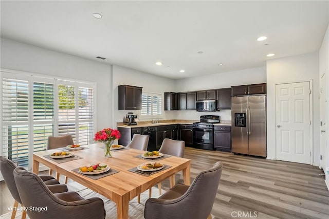 dining room featuring recessed lighting and light wood-style flooring