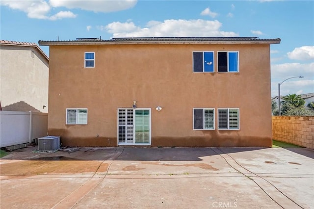 back of house featuring stucco siding, a patio, and fence