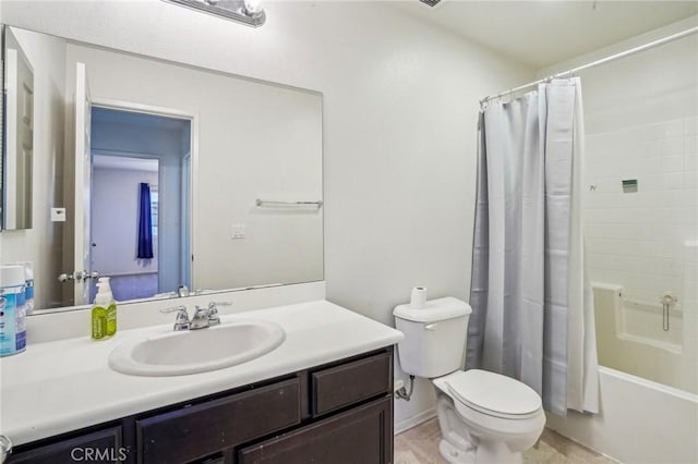 full bathroom featuring shower / bath combination with curtain, toilet, and vanity