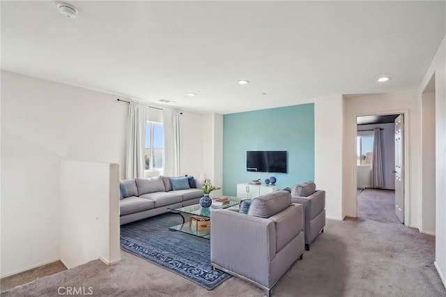 living area featuring visible vents, recessed lighting, baseboards, and carpet