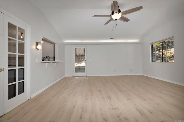 unfurnished living room with lofted ceiling, light wood-style flooring, plenty of natural light, and ceiling fan