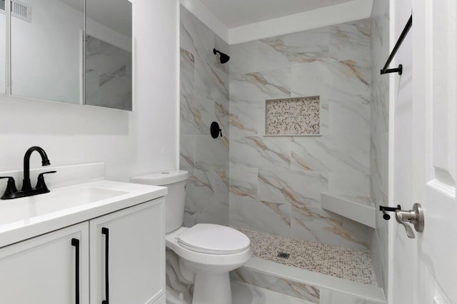 bathroom featuring a marble finish shower, visible vents, toilet, marble finish floor, and vanity