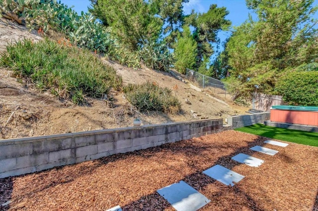 view of yard with a hot tub and fence