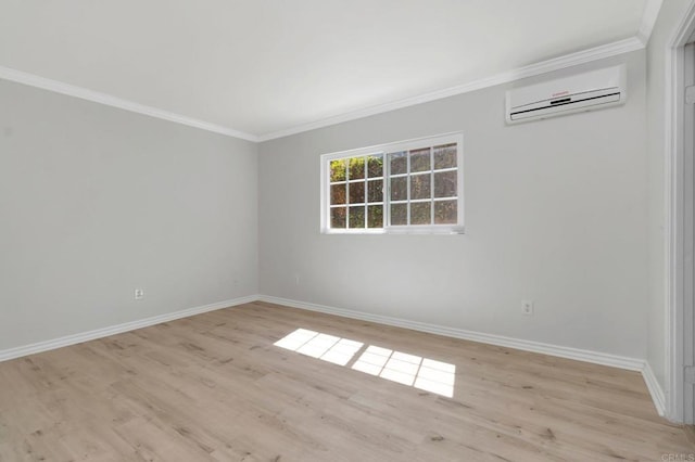 unfurnished room featuring crown molding, light wood-style floors, baseboards, and a wall mounted AC