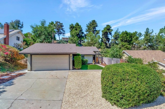 ranch-style home featuring concrete driveway, fence, a garage, and stucco siding