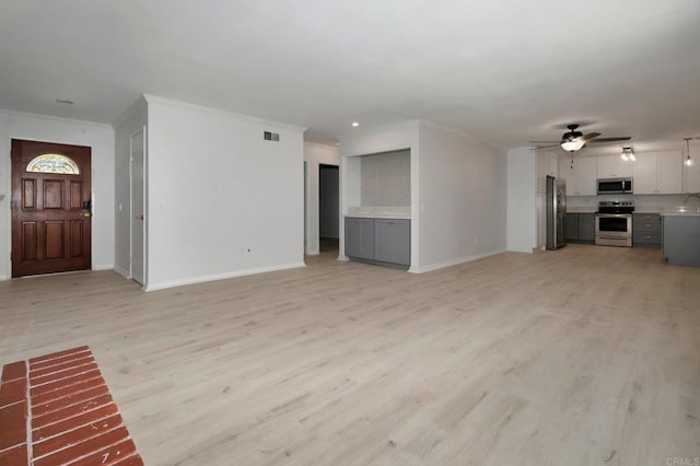 unfurnished living room featuring a ceiling fan, baseboards, light wood-type flooring, and ornamental molding