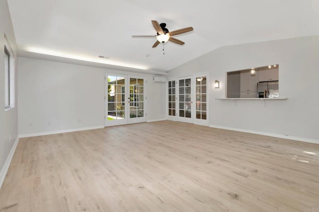 unfurnished living room featuring french doors, light wood finished floors, baseboards, and vaulted ceiling