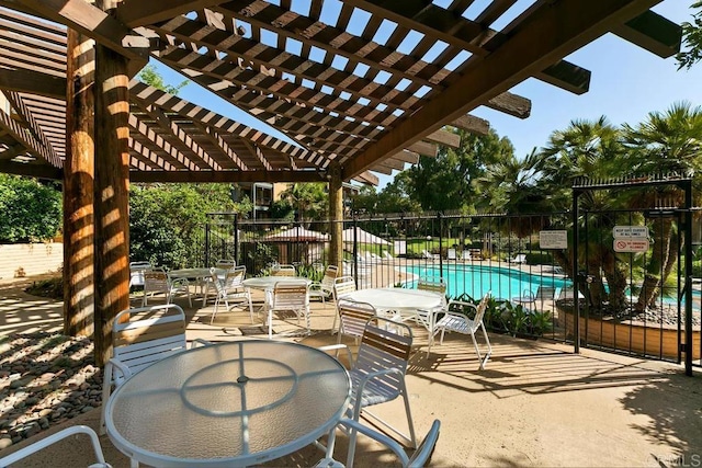 view of patio with a pergola, outdoor dining area, a community pool, and fence