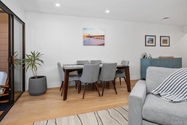 dining area with recessed lighting, light wood-type flooring, baseboards, and visible vents