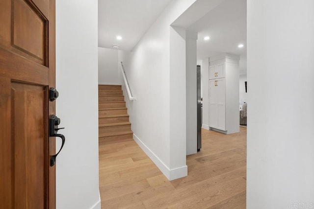 stairs with recessed lighting, baseboards, and wood finished floors