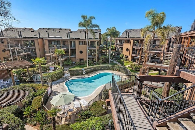 community pool with stairway and a residential view