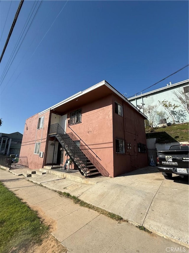 view of property exterior featuring stairway and stucco siding