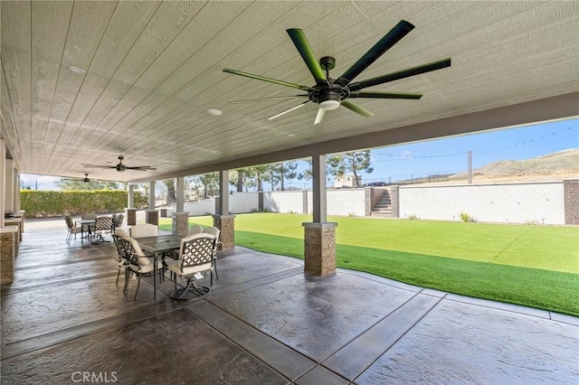 view of patio / terrace featuring outdoor dining area, ceiling fan, and fence