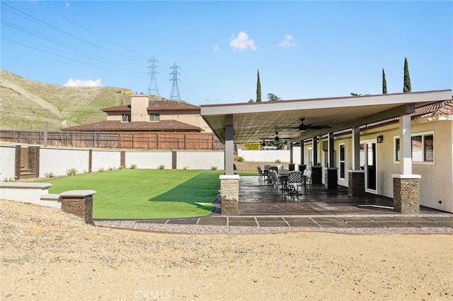 view of patio / terrace featuring a ceiling fan and fence