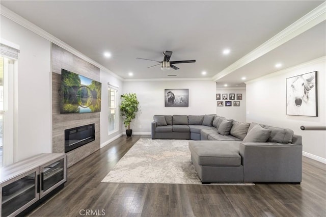 living room with baseboards, a healthy amount of sunlight, dark wood-style floors, and a fireplace