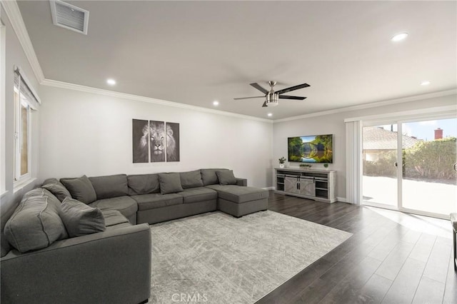 living area featuring recessed lighting, dark wood-style floors, visible vents, and ornamental molding