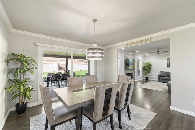 dining space with a fireplace, dark wood-style floors, and baseboards