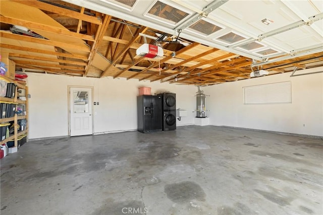 garage with black fridge with ice dispenser, a garage door opener, water heater, and stacked washing maching and dryer