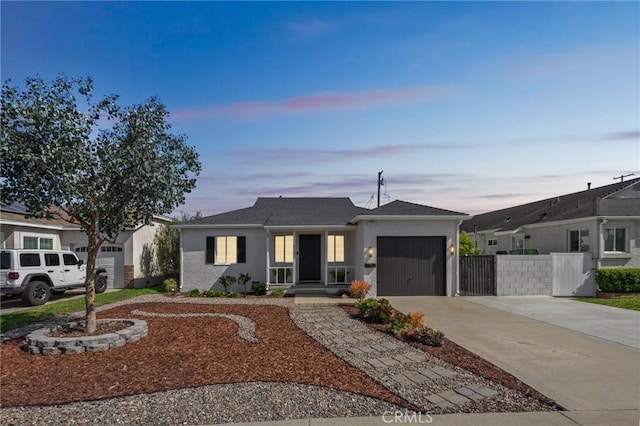 ranch-style home with stucco siding, a garage, driveway, and fence