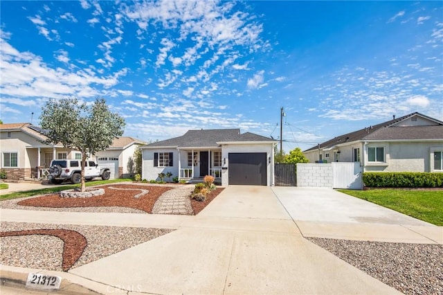 ranch-style house with stucco siding, driveway, a gate, fence, and a garage