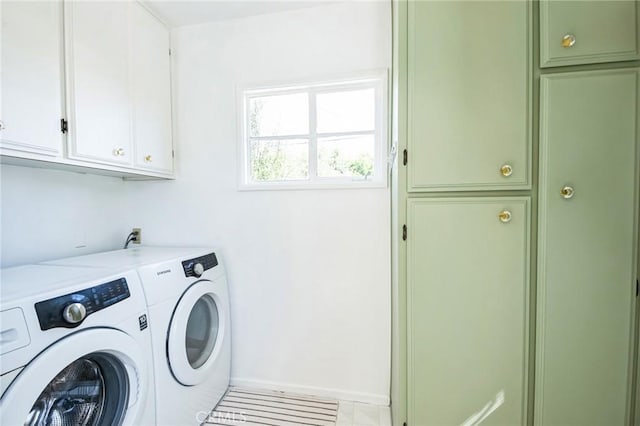 laundry room with cabinet space, washer and dryer, and baseboards