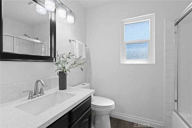 full bath with baseboards, toilet, wood finished floors, and vanity