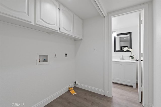 laundry area featuring electric dryer hookup, cabinet space, light wood-style floors, and hookup for a washing machine