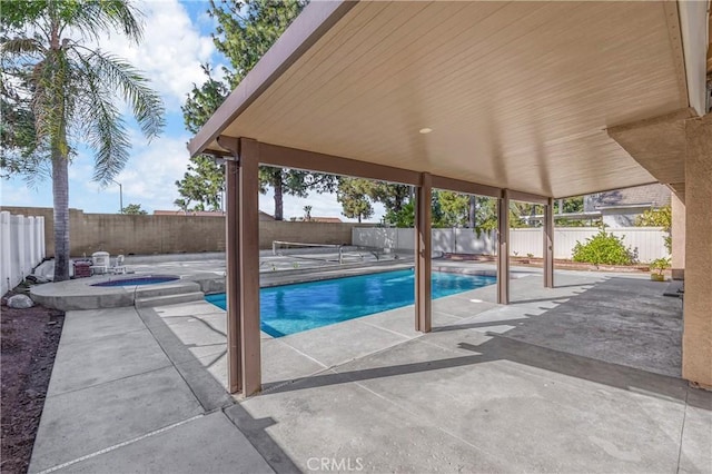 view of swimming pool featuring a patio, a fenced backyard, a fenced in pool, and an in ground hot tub