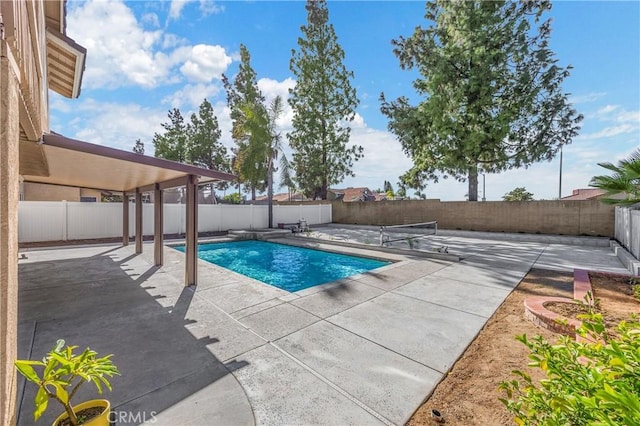 view of pool featuring a patio, a fenced backyard, and a fenced in pool