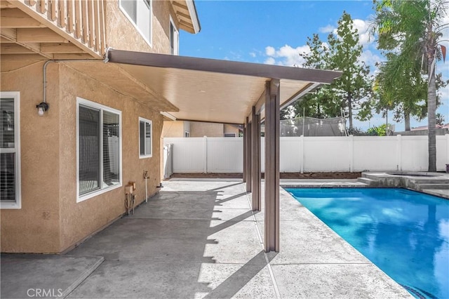 view of swimming pool with a fenced backyard, a fenced in pool, and a patio