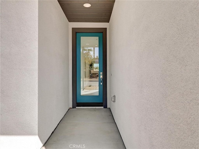 entrance to property featuring stucco siding