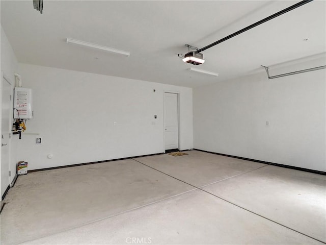 garage featuring a garage door opener, water heater, and baseboards