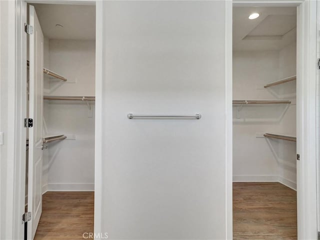 walk in closet with wood finished floors