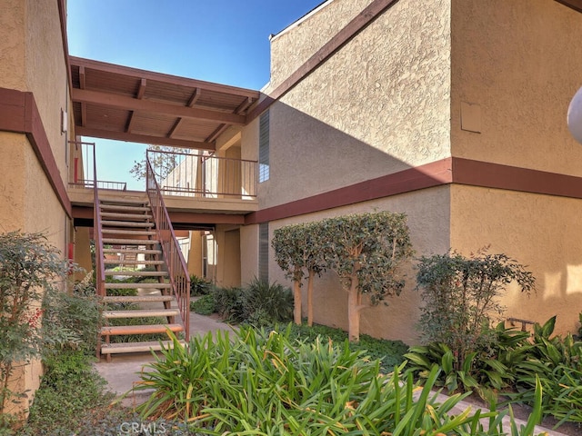 entrance to property featuring stucco siding