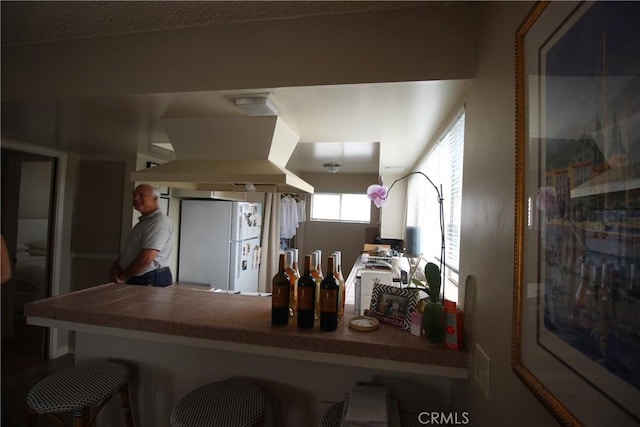 508 30th St, Hermosa Beach, CA 90254 - kitchen with exhaust hood, freestanding refrigerator, and a kitchen bar