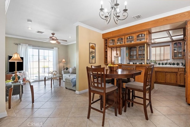 dining area featuring light tile patterned flooring, visible vents, and ornamental molding